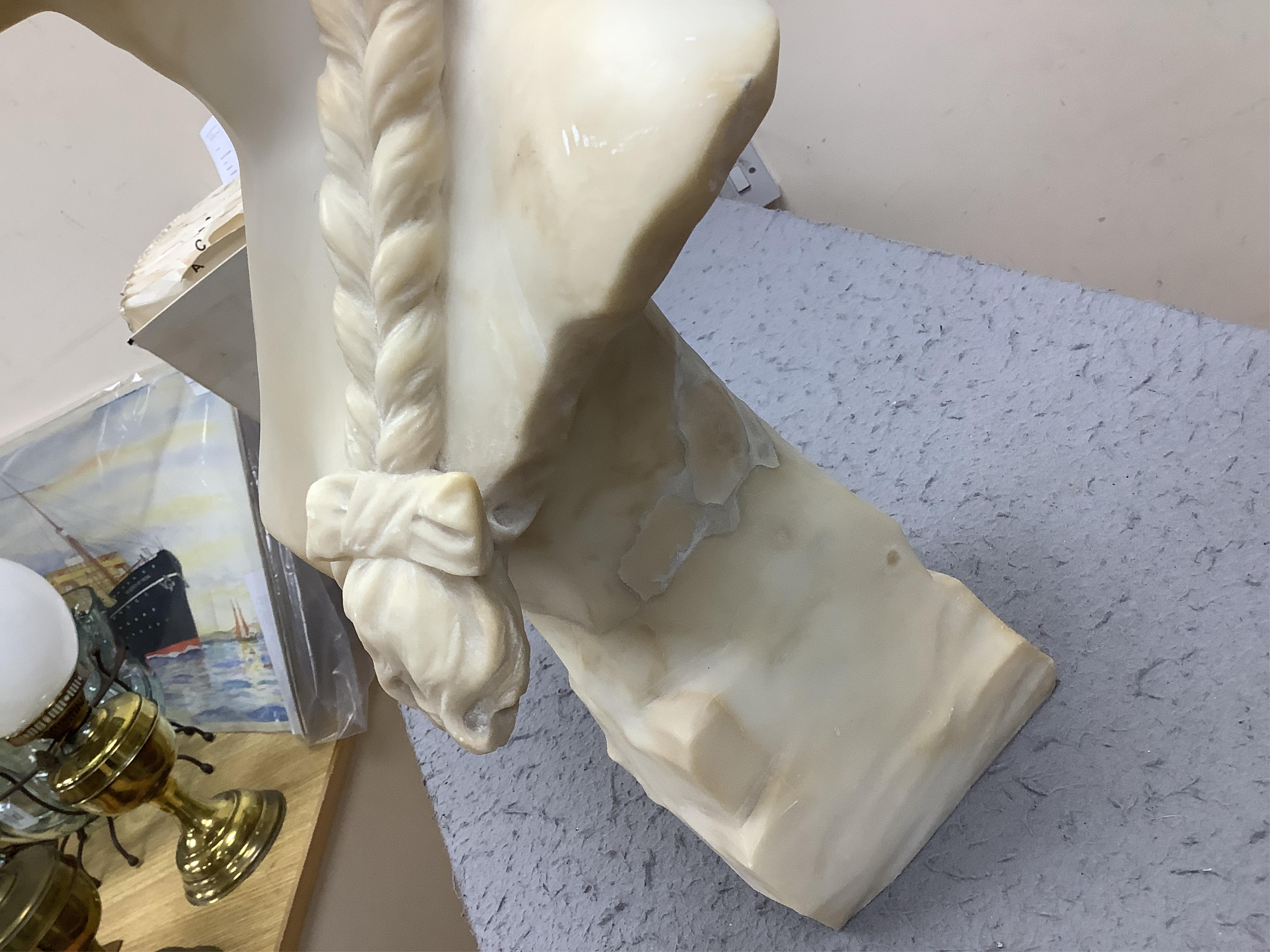 A French alabaster bust of a girl with long plait wearing a hat, signed on the back of pedestal, 54cm high. Condition - good